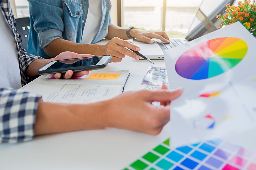 asian advertising designer creative start up team discussing ideas office